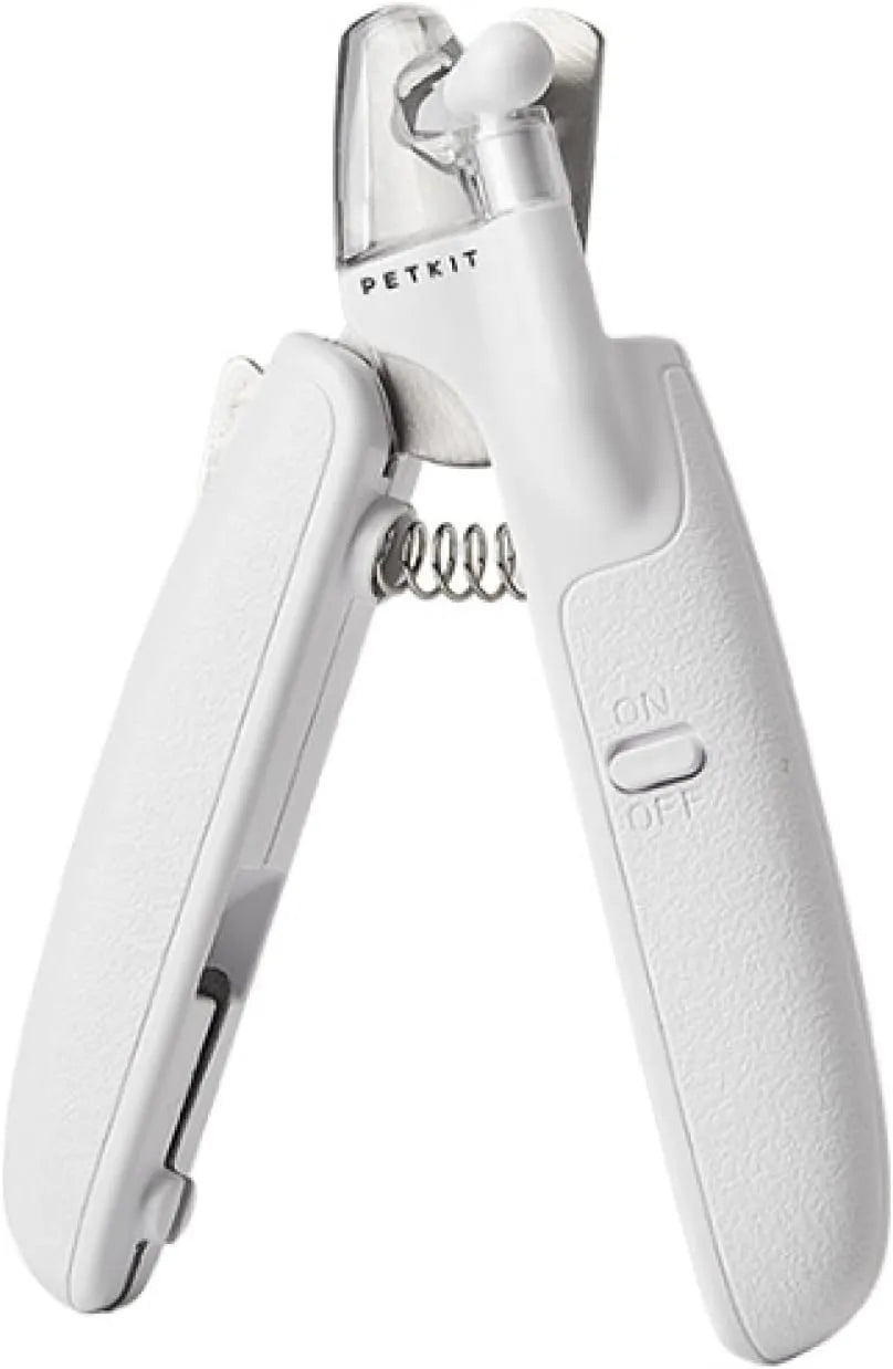 White pet nail clippers with LED light, transparent guard, and nail file on a grey background.