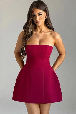 Stylish backless tube dress in a variety of colors, including black, white, and pink, showcasing a flattering A-line silhouette and premium construction.