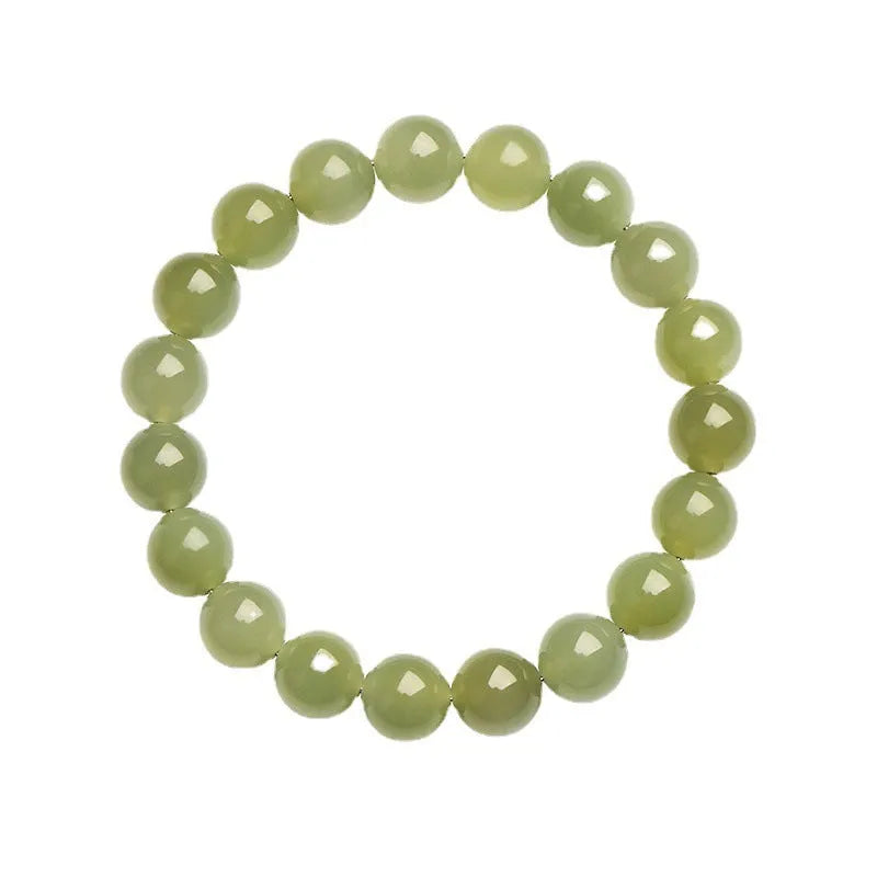 Polished Hetian jade beaded bracelet on a wrist, showing ice-like clear colour tones and spherical beads.