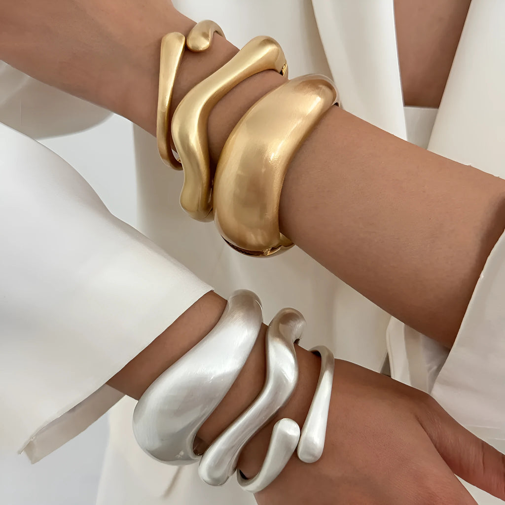 Metal alloy opening bracelet in matte or glossy finish with ellipse design element cold wind style