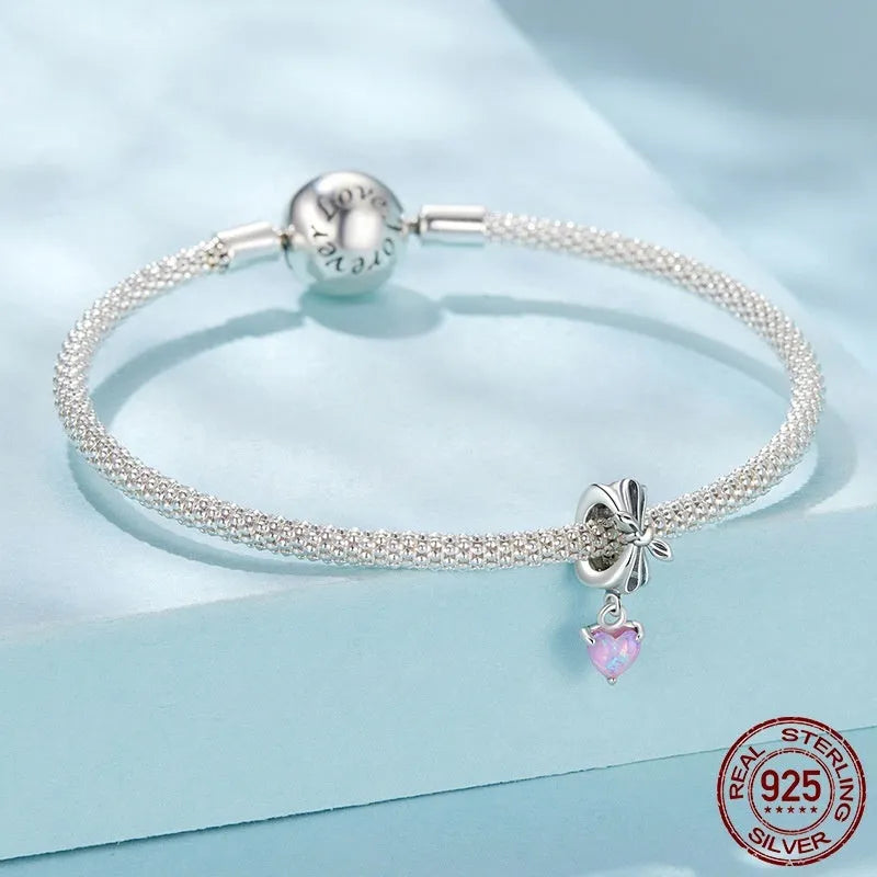 S925 sterling silver pendant with opal bow and loving heart motif, 1.6cm height, on white background