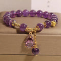 Natural amethyst bracelet with gold-plated inlay and purple droplet pendant on white background