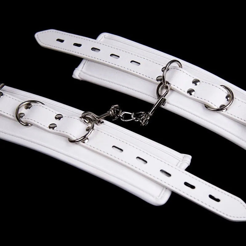 White PU sponge adult bondage set showing handcuffs, footcuffs, and a neck scarf.
