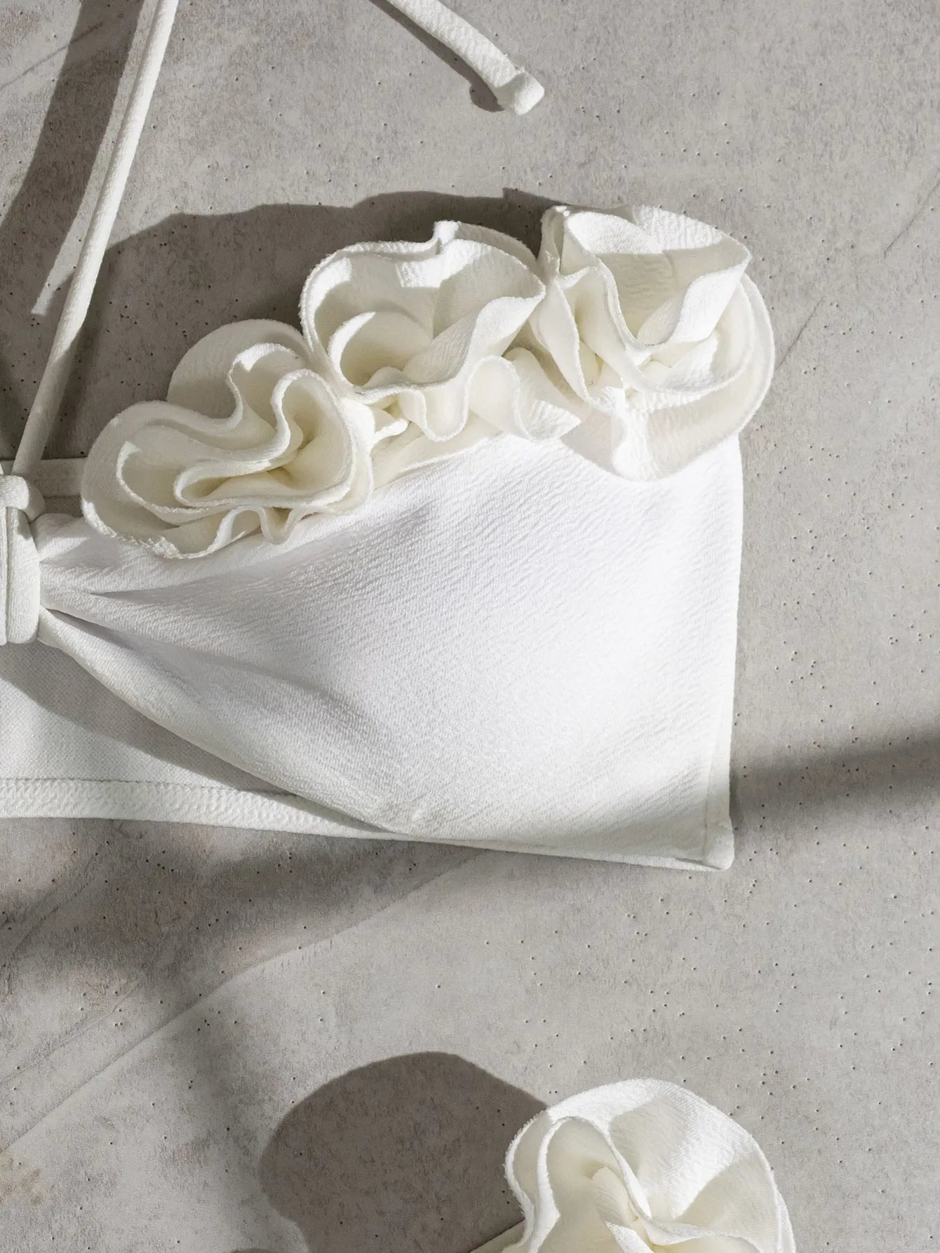 White halter neck bikini set with 3D flower design and lace-up back