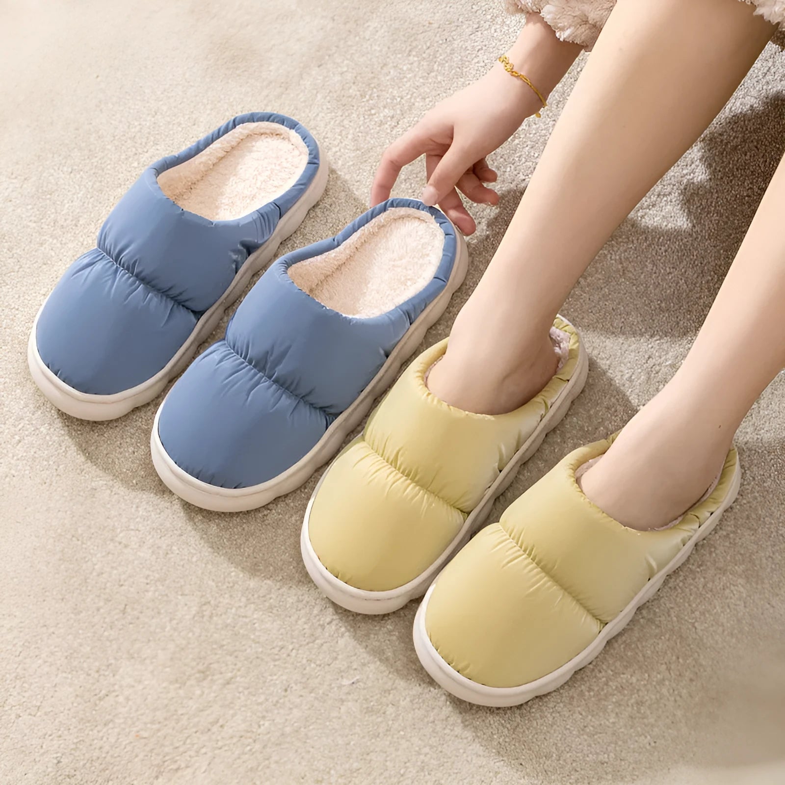 A pair of blue down cotton slippers with a thick sole, artificial leather upper, and plush lining for indoor winter wear.