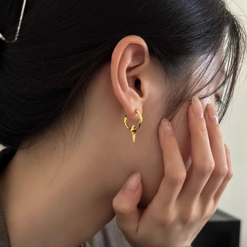 Gold plated geometric star earrings with copper construction and XINGX ear clip design