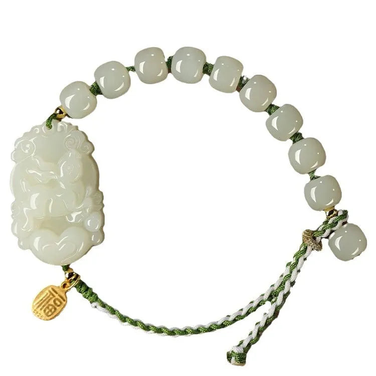 Year of the Rabbit red cord bracelet with Hetian jade charm and small silver blessing card.