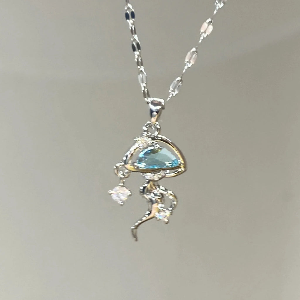 Blue jellyfish pendant on a white gold coloured adjustable sterling silver necklace chain.