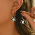 A pair of silver-coloured retro-style fashion earrings for women.