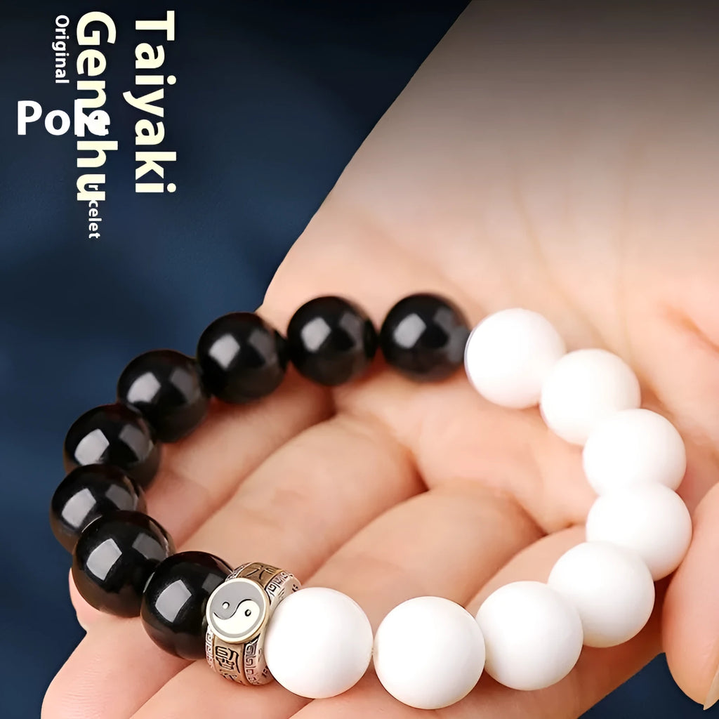 Black and white obsidian Taiji mantra bracelet with geometric beads and yin-yang symbol.