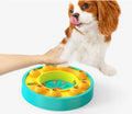 Square green dog puzzle feeder bowl with rotating turntable top and non-slip rubber base.