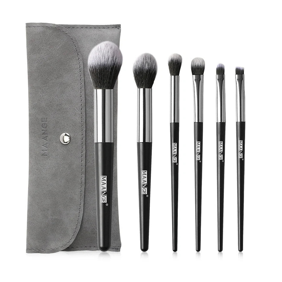 Six makeup brushes with black synthetic bristles and natural wood handles measuring 15cm