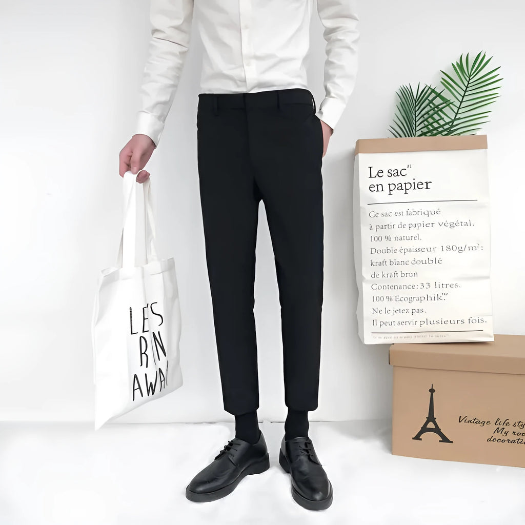 Men's slim straight-leg cotton trousers with a drawstring waist in black, shown front and side.