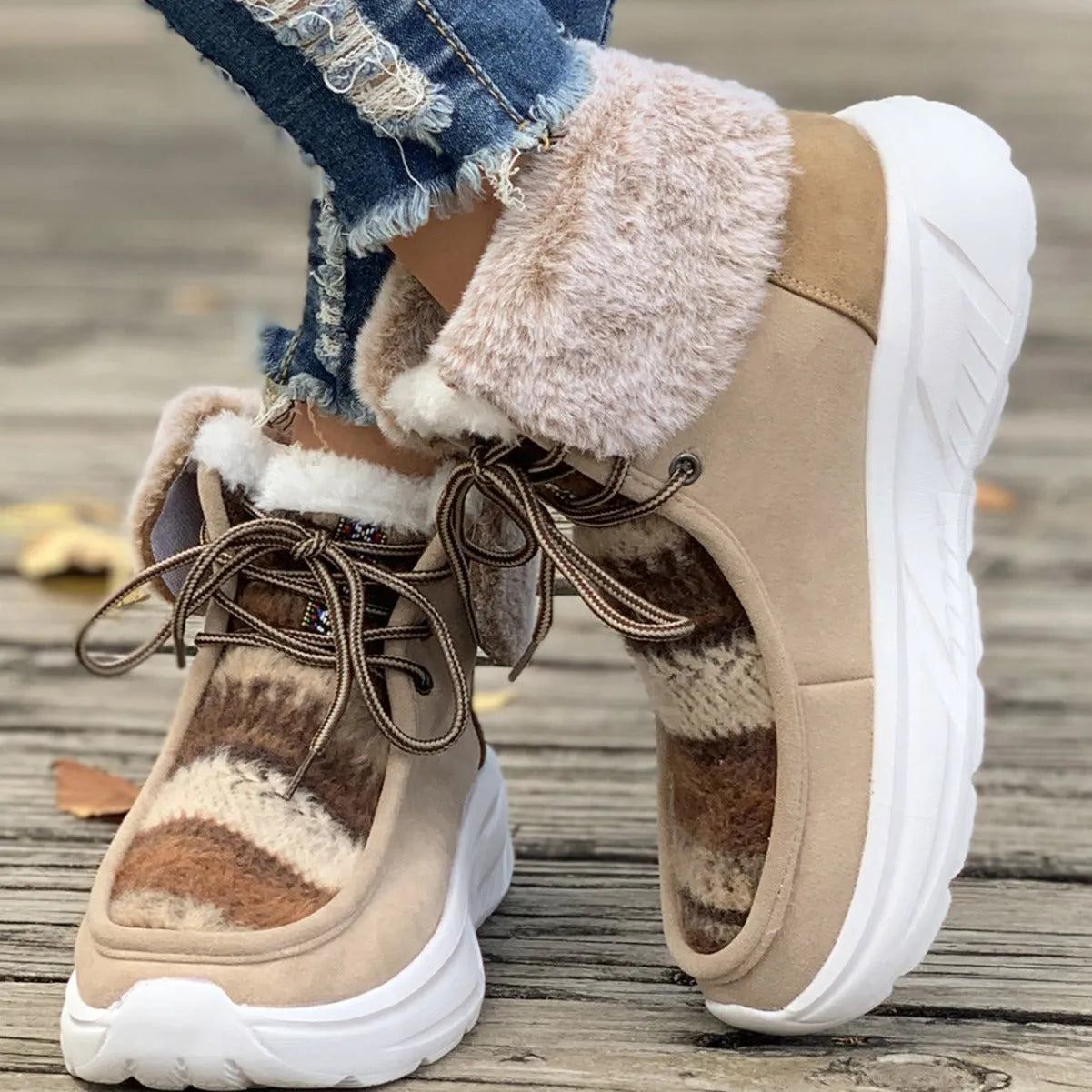Beige women's lace-up suede snow boots with fuzzy lining and a thick soft sole platform.