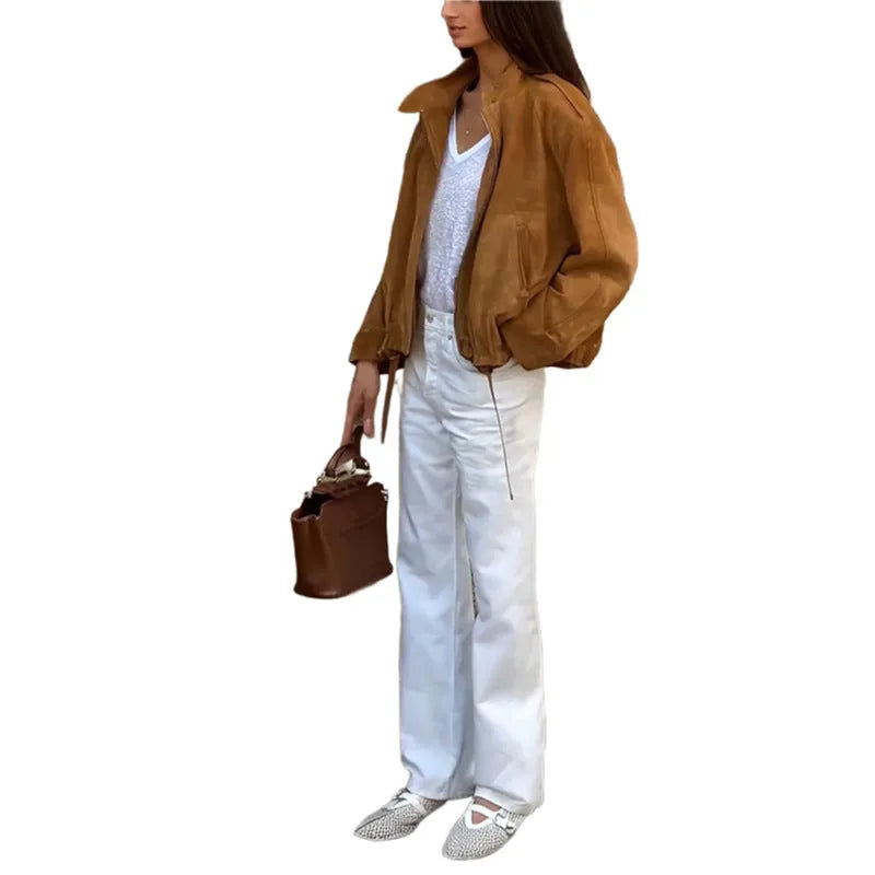 Solid colour loose-fit retro jacket with long sleeves on a hanger.