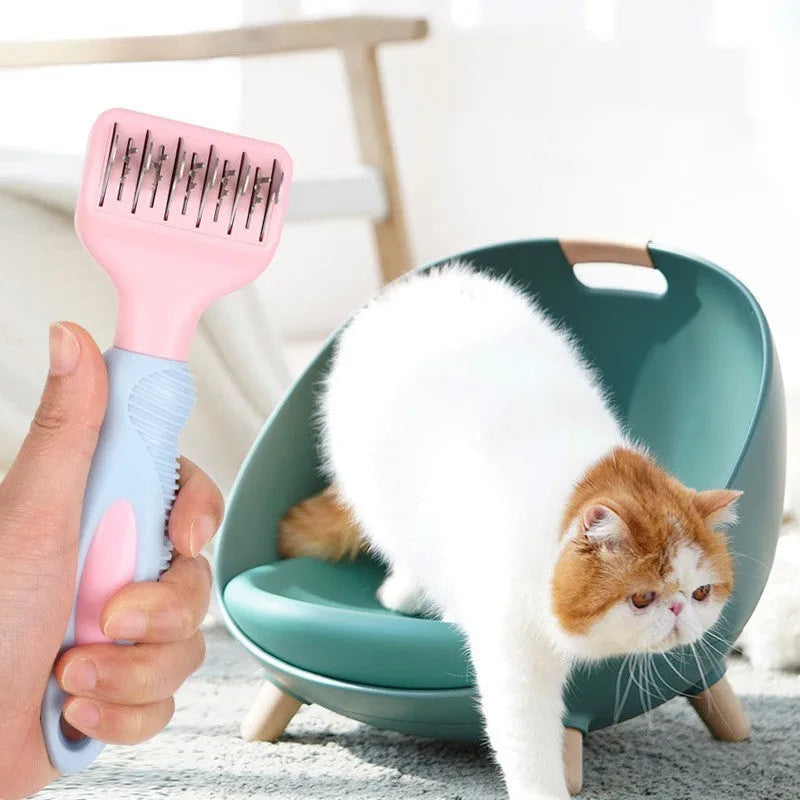 Pink dual-sided dog grooming comb with stainless steel blade and rotating ball-tip massage brush.