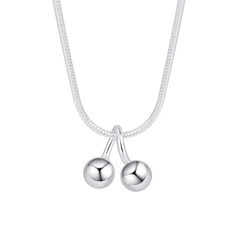 Silver cherry pendant necklace on an adjustable snake bone chain for women.