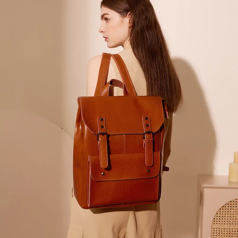 Women's structured backpack in genuine cowhide leather, shown in black, brown, and coffee colour options.