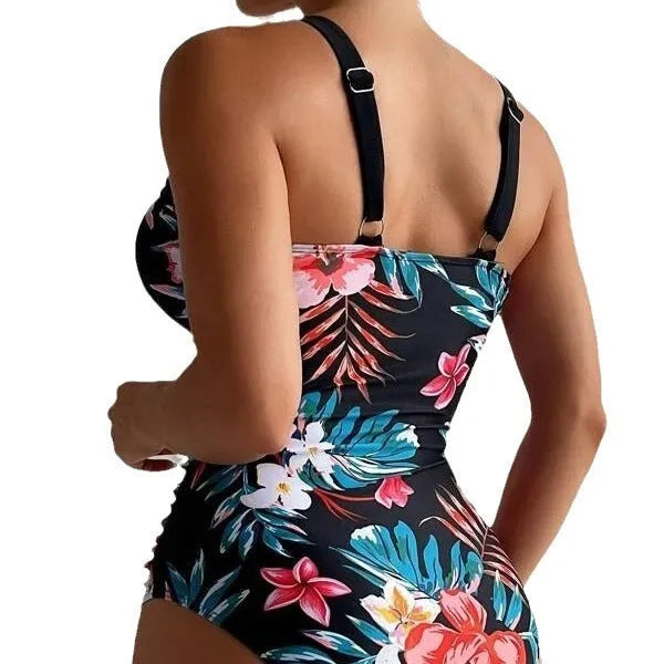 Women's black floral print one-piece swimsuit with a backless design.
