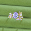 Women's open ring with flower design and zircon detail in light purple or yellow colour options
