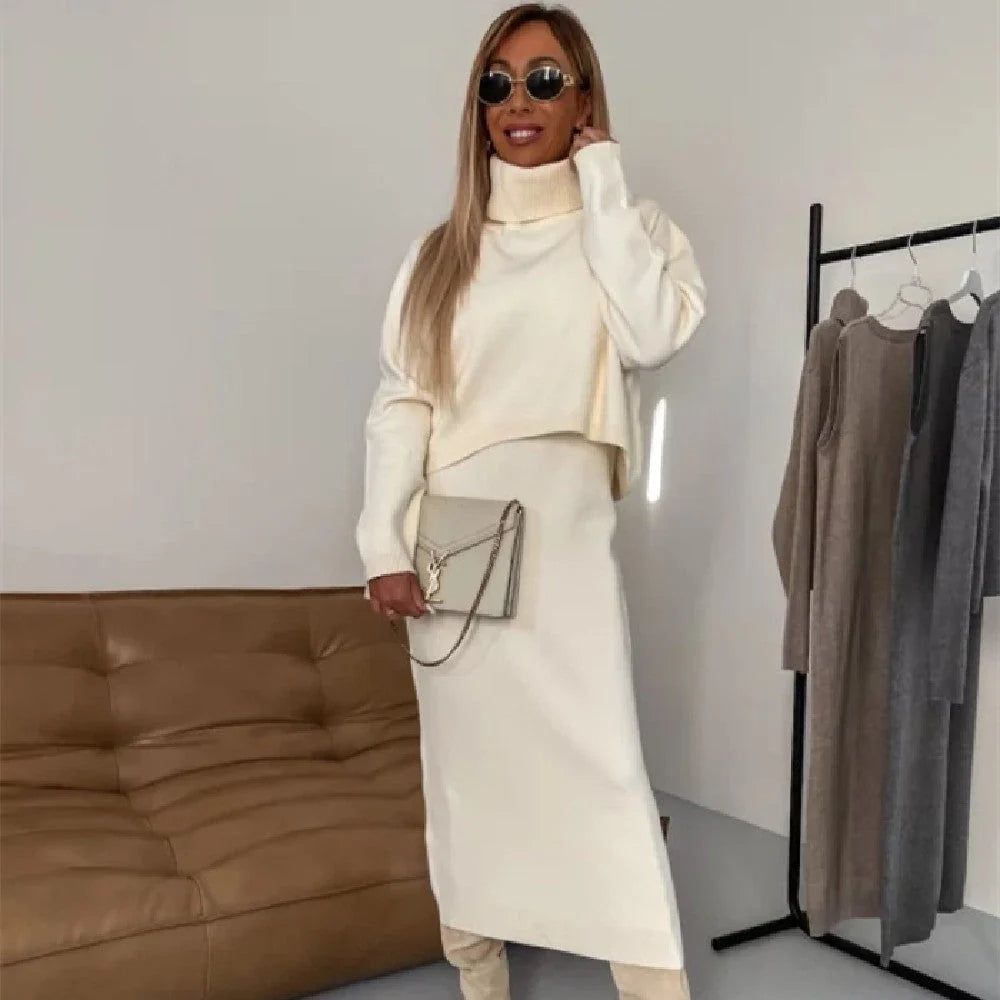 Women's winter fashion two-piece set featuring a turtleneck pullover and sleeveless long dress in white, grey, or camel.