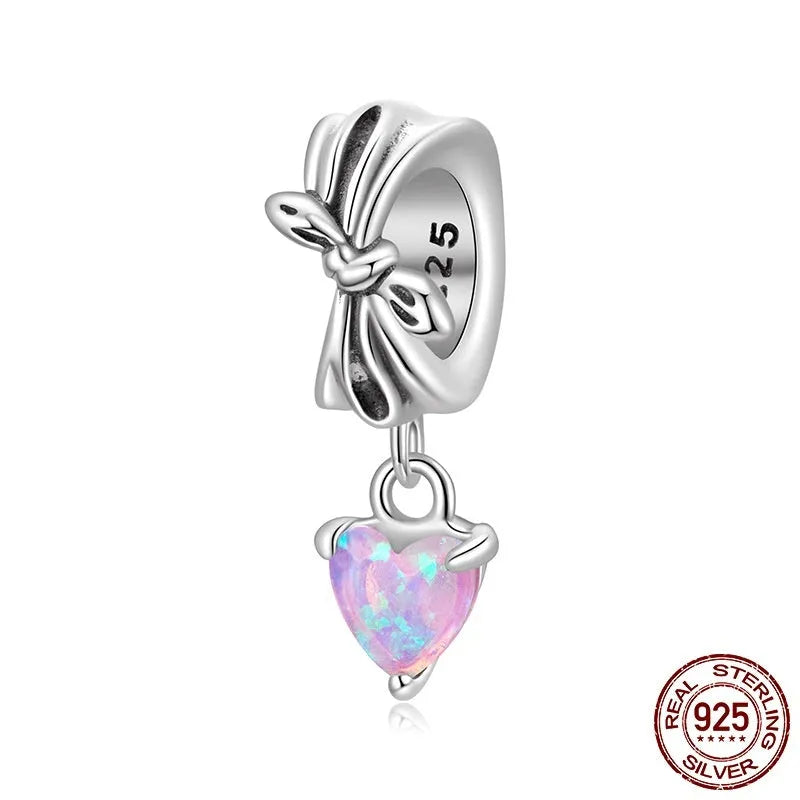 S925 sterling silver pendant with opal bow and loving heart motif, 1.6cm height, on white background