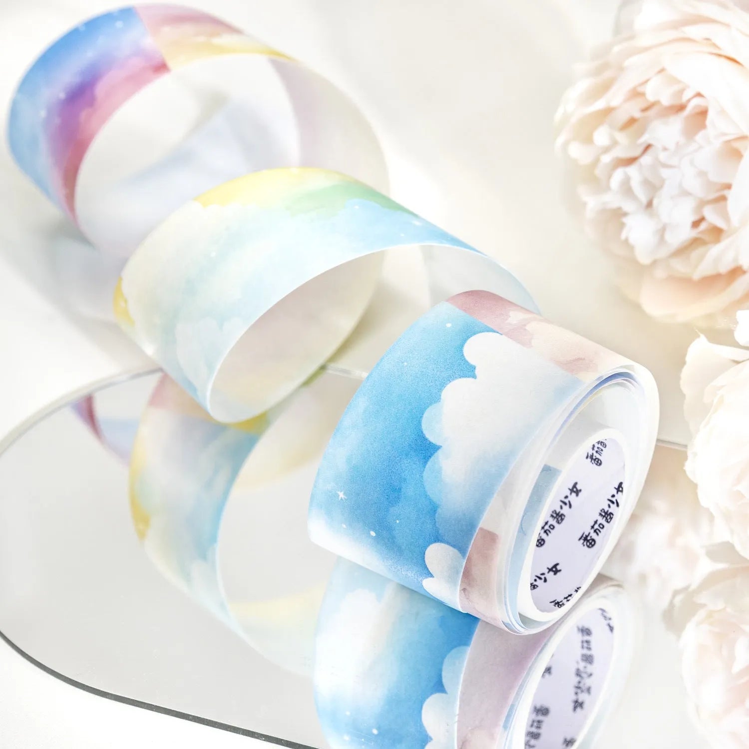 Japanese paper washi tape roll with sky theme designs including clouds, sun, moon, and nebula patterns