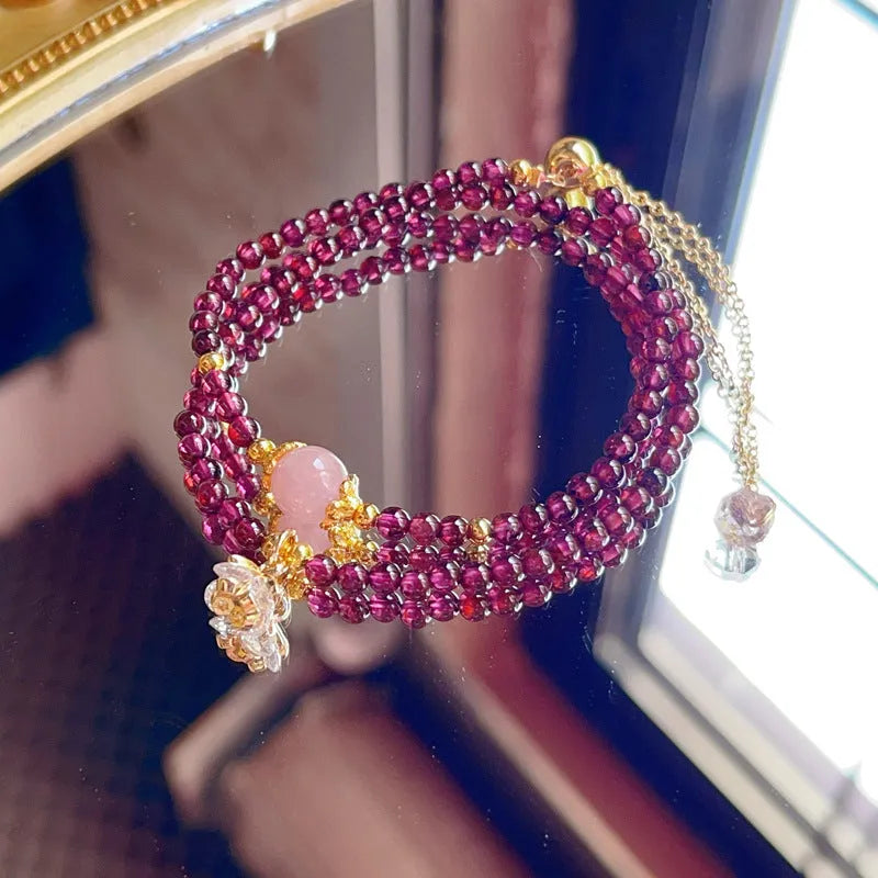Women's double ring bracelet with natural red garnet beads and adjustable clasp.