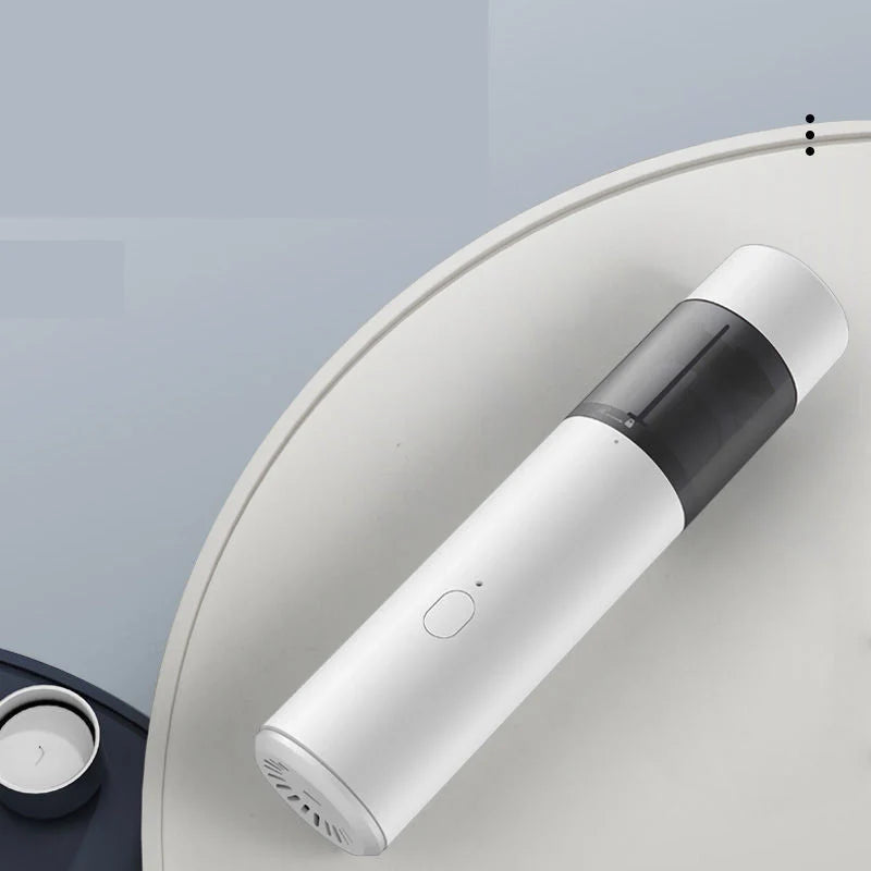 Mini car vacuum cleaner with wireless charging in black and white