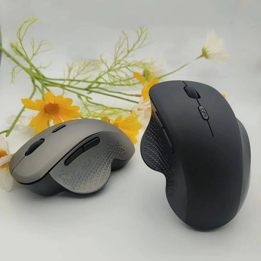 Black or grey wireless laptop mouse with USB charging cable on white background