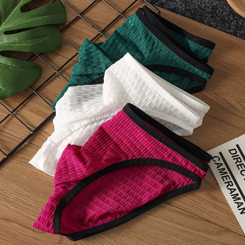 Men's low waist transparent nylon lace underwear in a solid colour with text print.