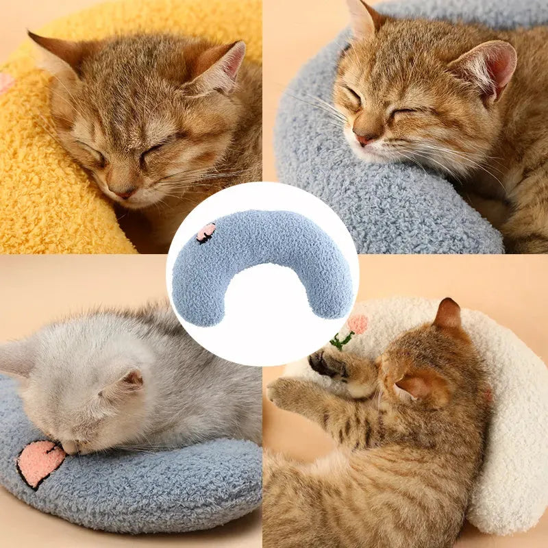 A small blue U-shaped plush pillow for a cat or small dog to sleep in.