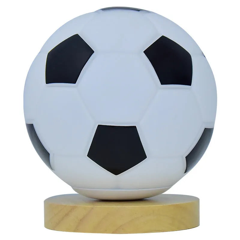 Football LED small night lamp with glass shade and remote control on a bedside table