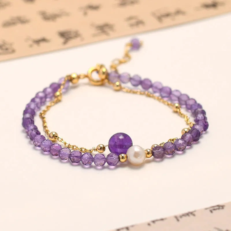 Close-up of a women's amethyst bracelet with diamond-cut crystal beads and Chinese style design.