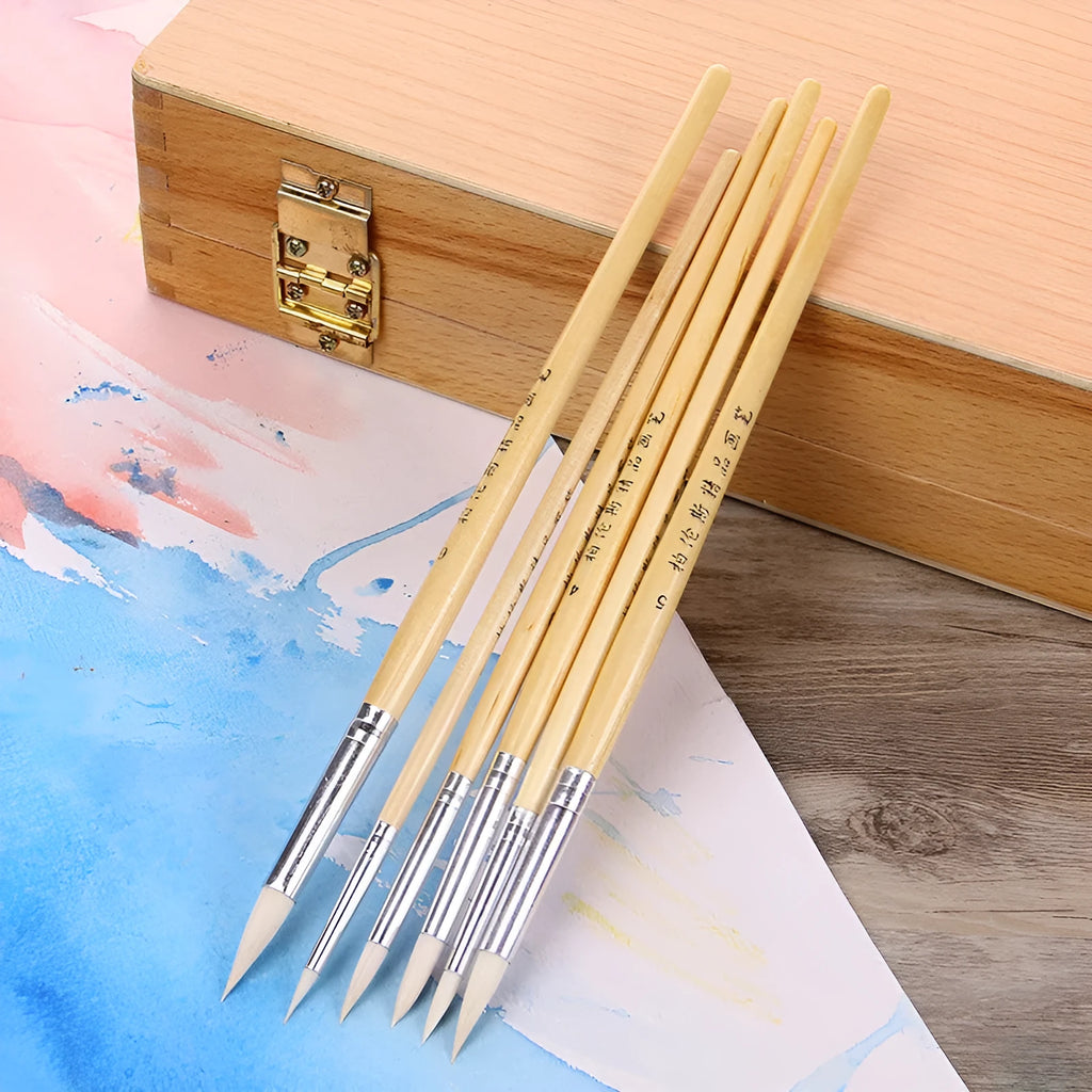 6 wooden artist paintbrushes with pointed handles and wool brush heads arranged together