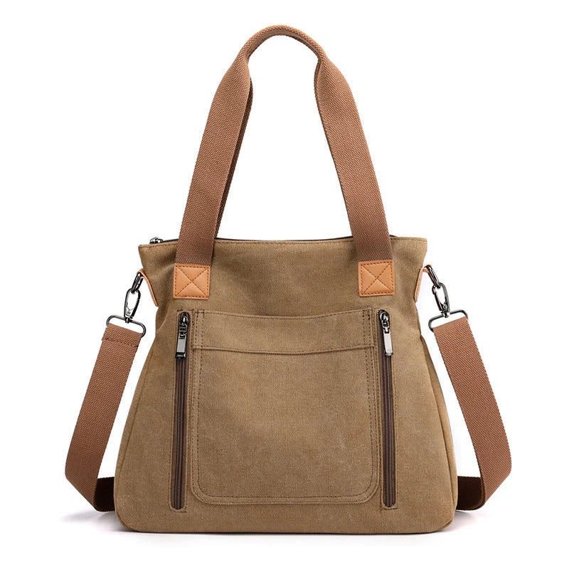 Women's canvas shoulder bag in multiple colours, showcasing spacious interior and zipper closure.