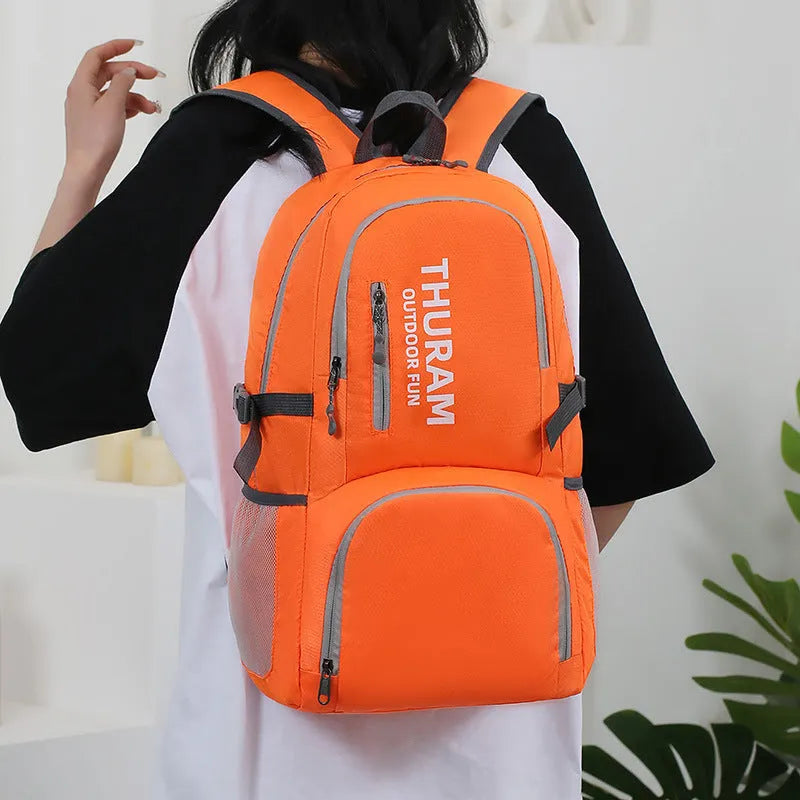 Outdoor folding shoulder travel bag in Oxford cloth with 20-35L capacity and air pillow belt