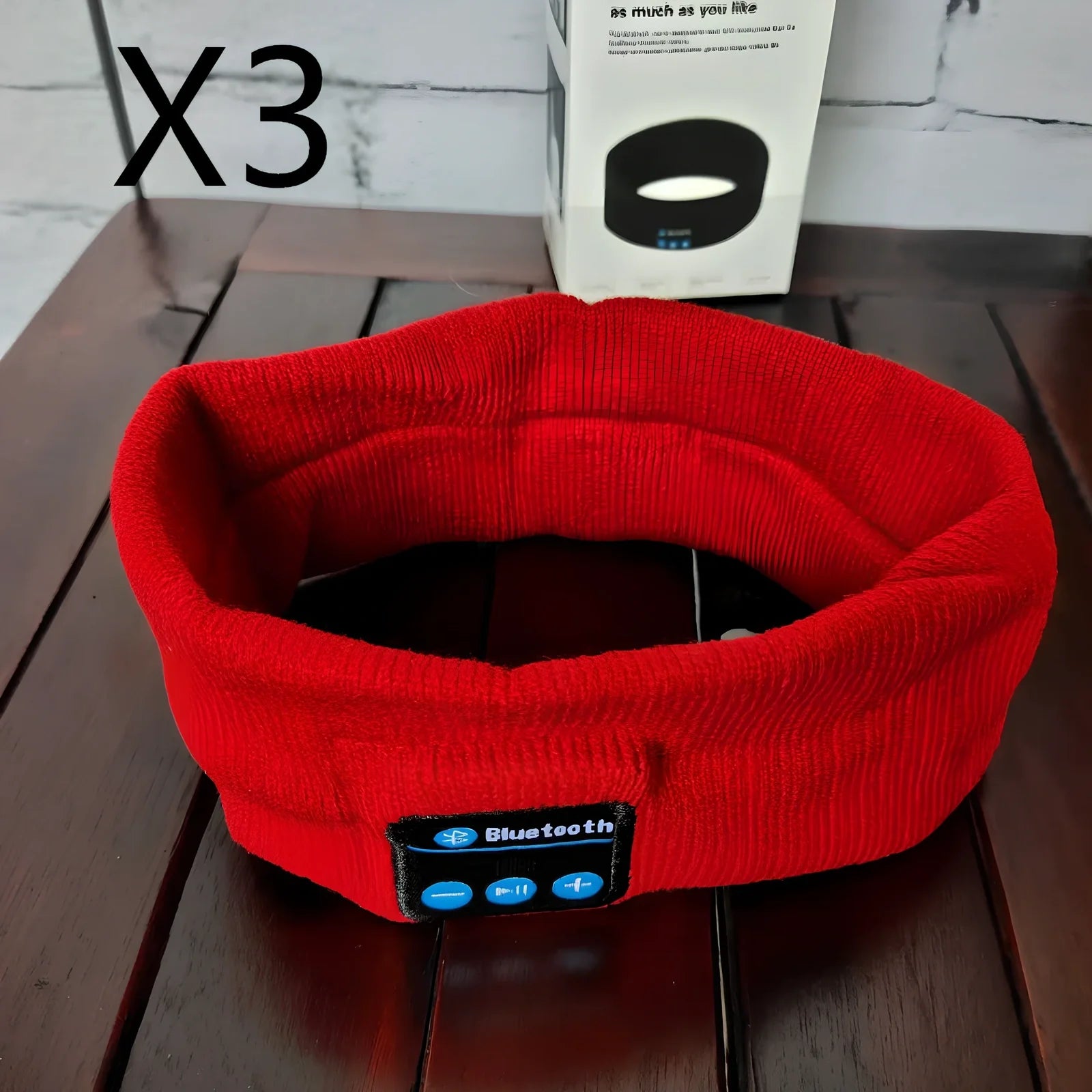 Black Bluetooth sports headband with integrated audio controls and 110mAh battery for workouts