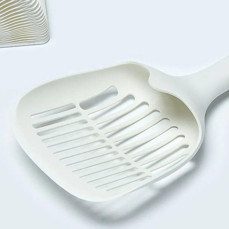 White plastic cat litter scoop with storage base for litter tray cleaning