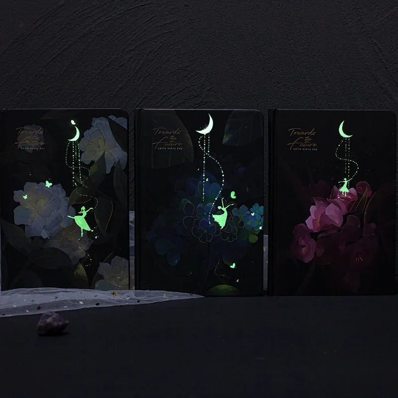 A5 notebook with luminous cover open to show colour illustration inside, in deep blue colour option.