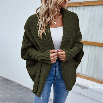 A cozy, oversized knit cardigan with a unique bat-wing sleeve design and large lapel, available in a variety of stylish colors.