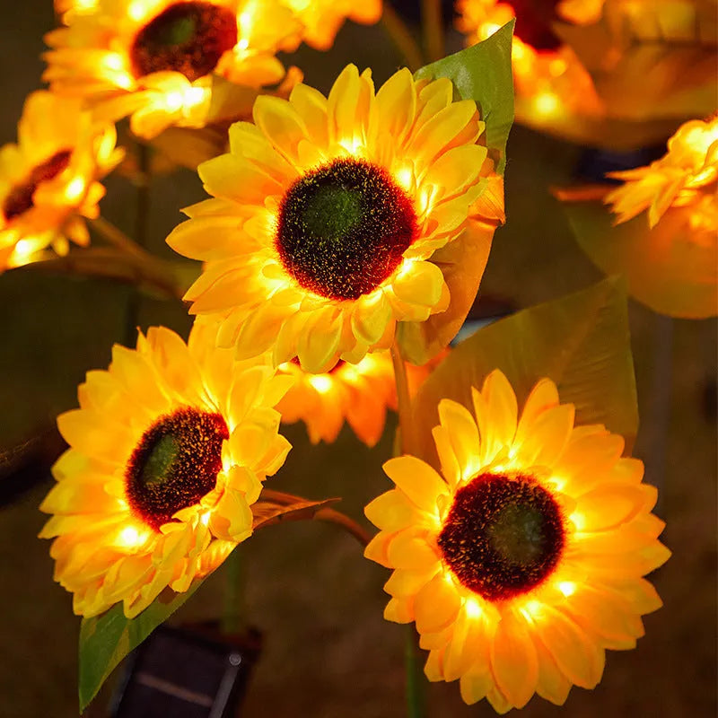 Solar sunflower lawn lamp with three sunflower heads on stainless steel stem in garden