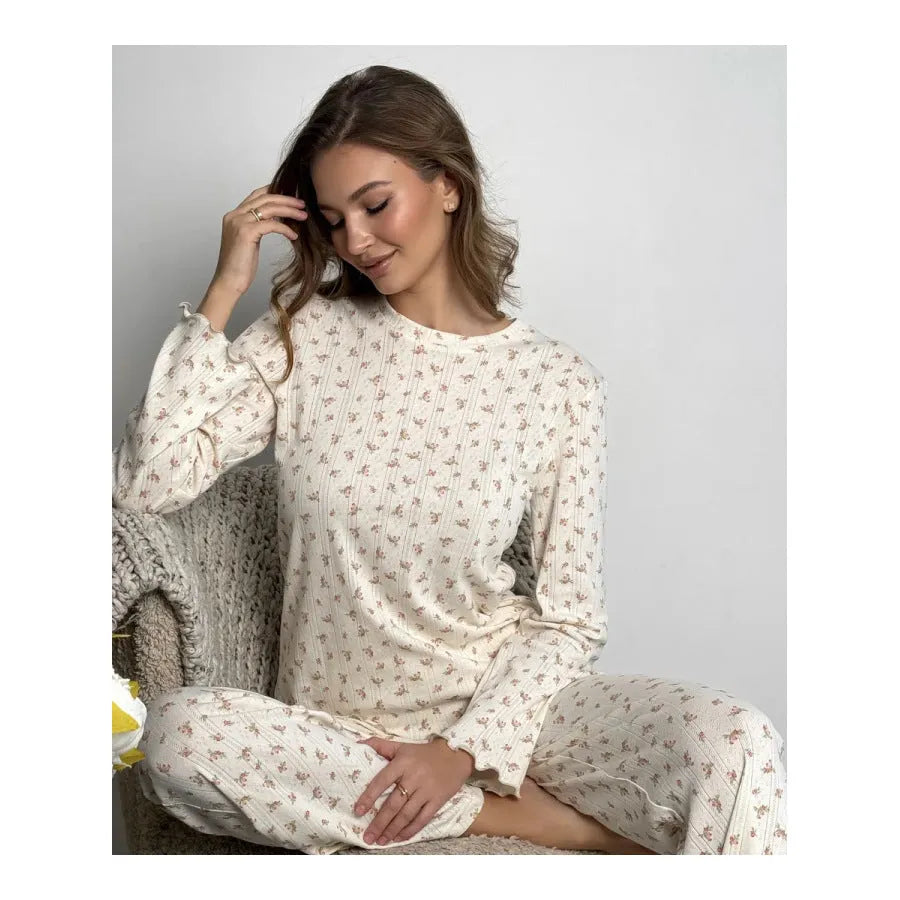 White women's floral print lounge suit with long bell sleeve top and wide leg trousers.