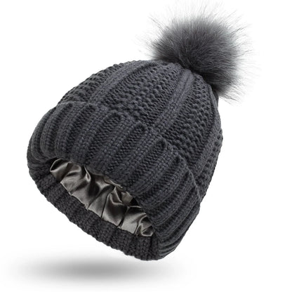 Wool skull knit beanie with satin lining and faux fur pom pom in various colours