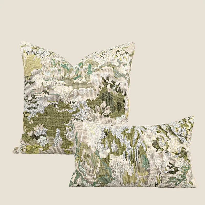 Green antique French style floral pattern wool blend decorative pillow on a sofa.