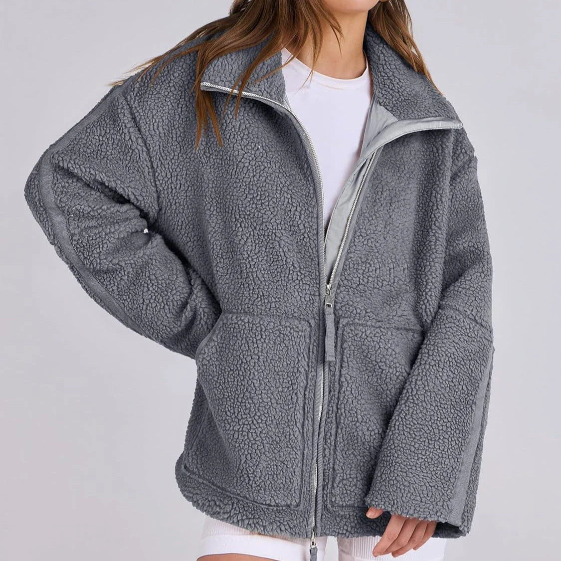 A versatile fleece jacket with a stylish lapel design, practical side pockets, and a cozy long-sleeve silhouette for cold-weather wear.