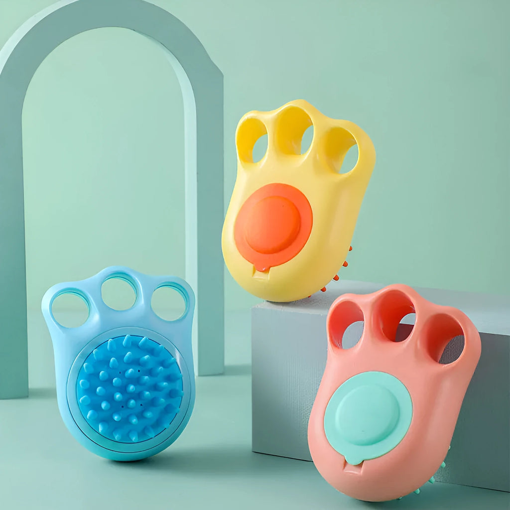 Cat claw-shaped silicone pet bath brush with suction cup base, shown in blue colour.