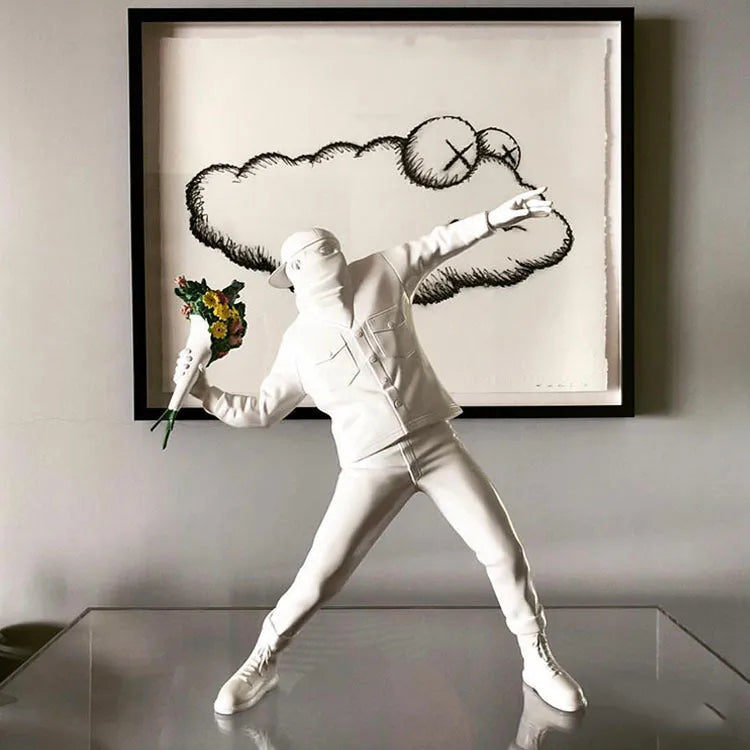 Banksy Throw Flower Boy polystone sculpture 44 cm black version on a shelf