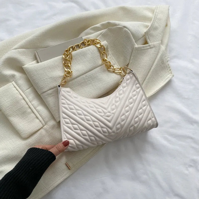 Brown pleated chain strap baguette shoulder bag showing vertical square shape and soft handle.