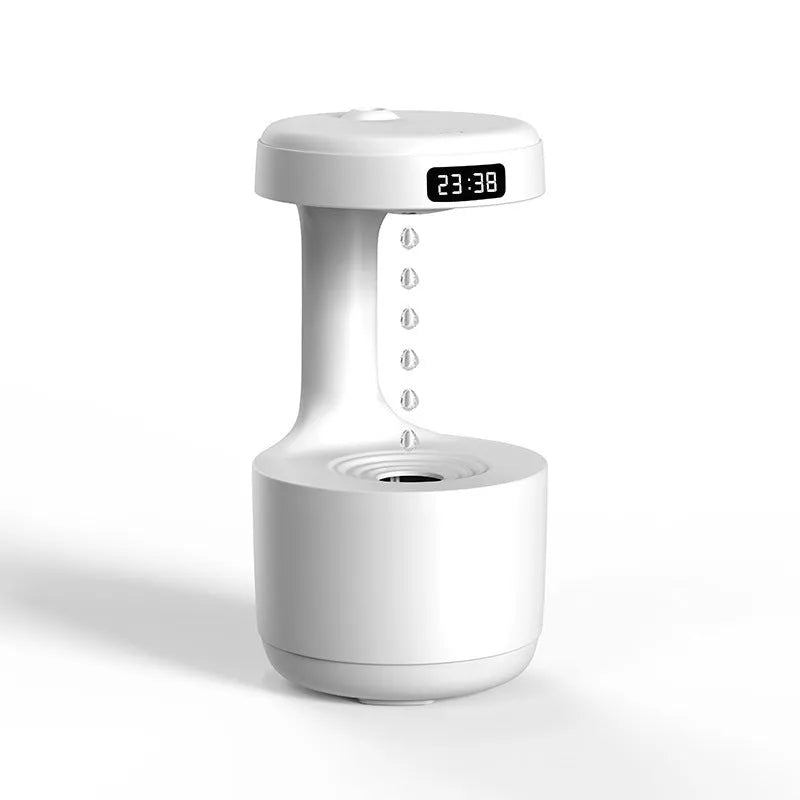 Rose gold and white columnar humidifier with levitating water drops and LED glow on a desk